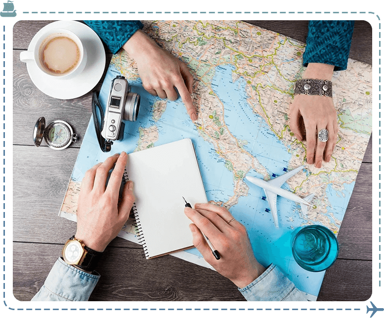 Two people are sitting at a table with a map and camera.