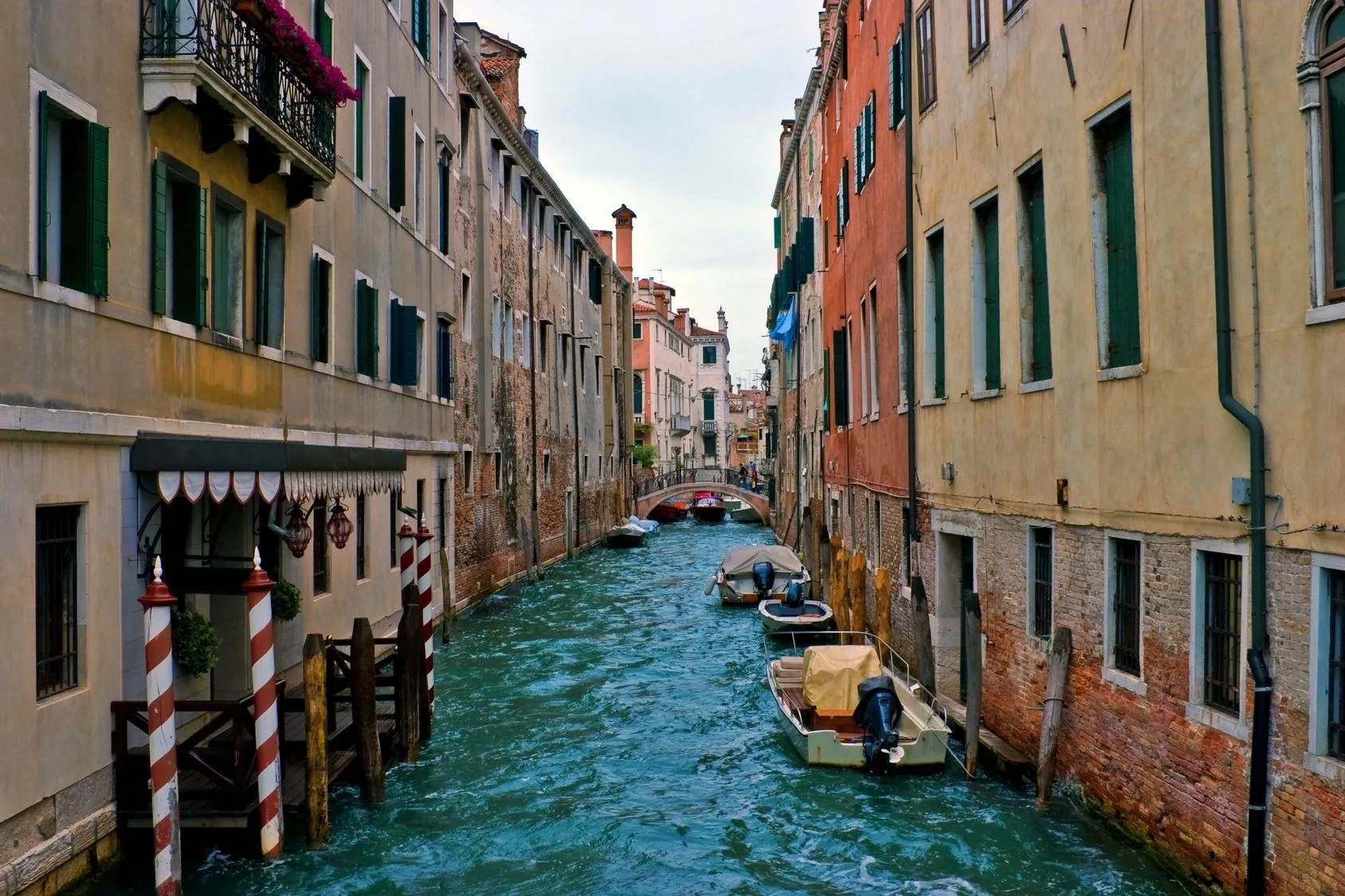 A canal with boats in it and buildings on the side.